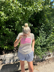Woman in yellow tee shirt with "Aloha" i pink text