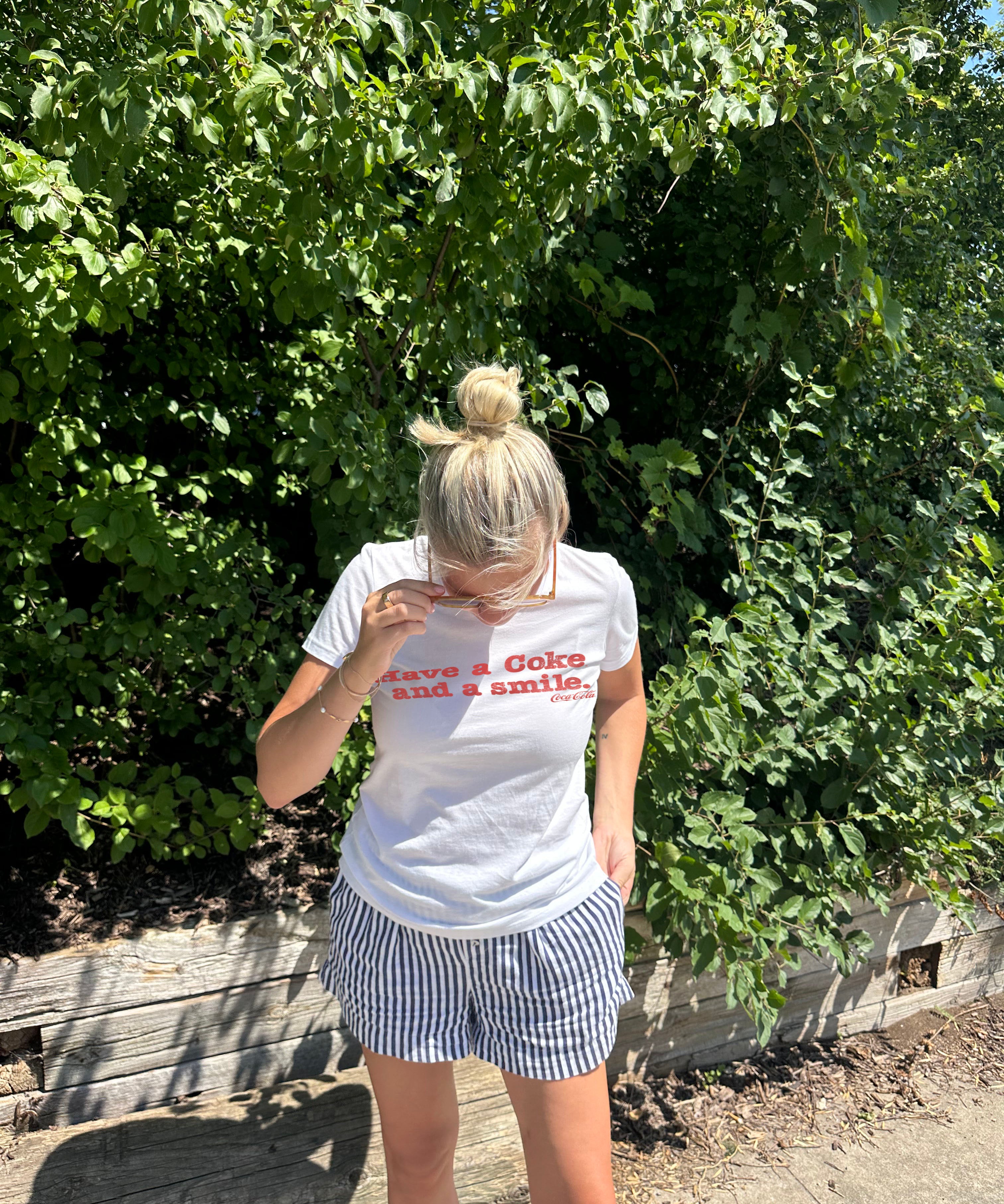 Have a coke and a smile white tee shirt with red letters
