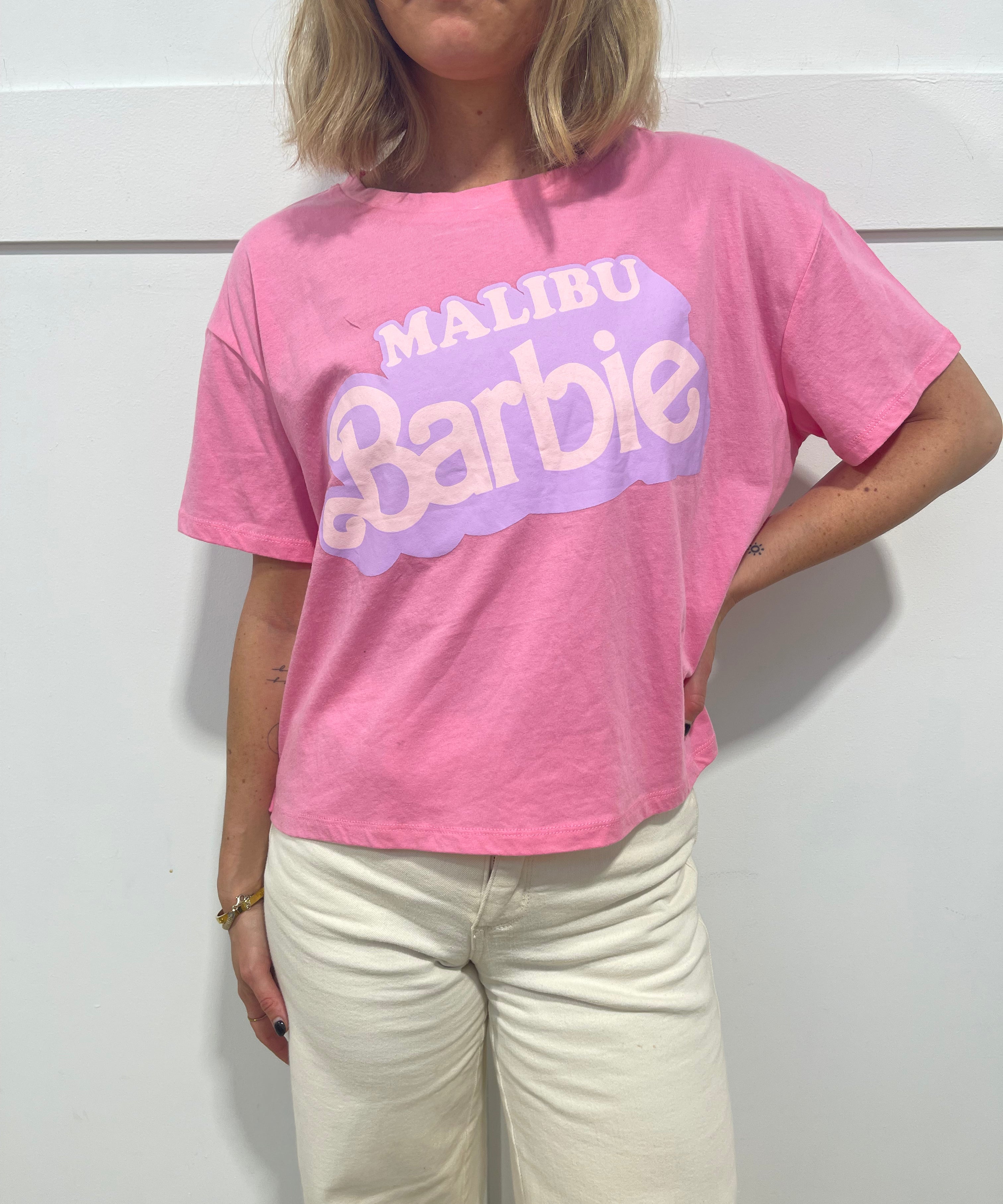 woman in pink Malibu barbie t shirt