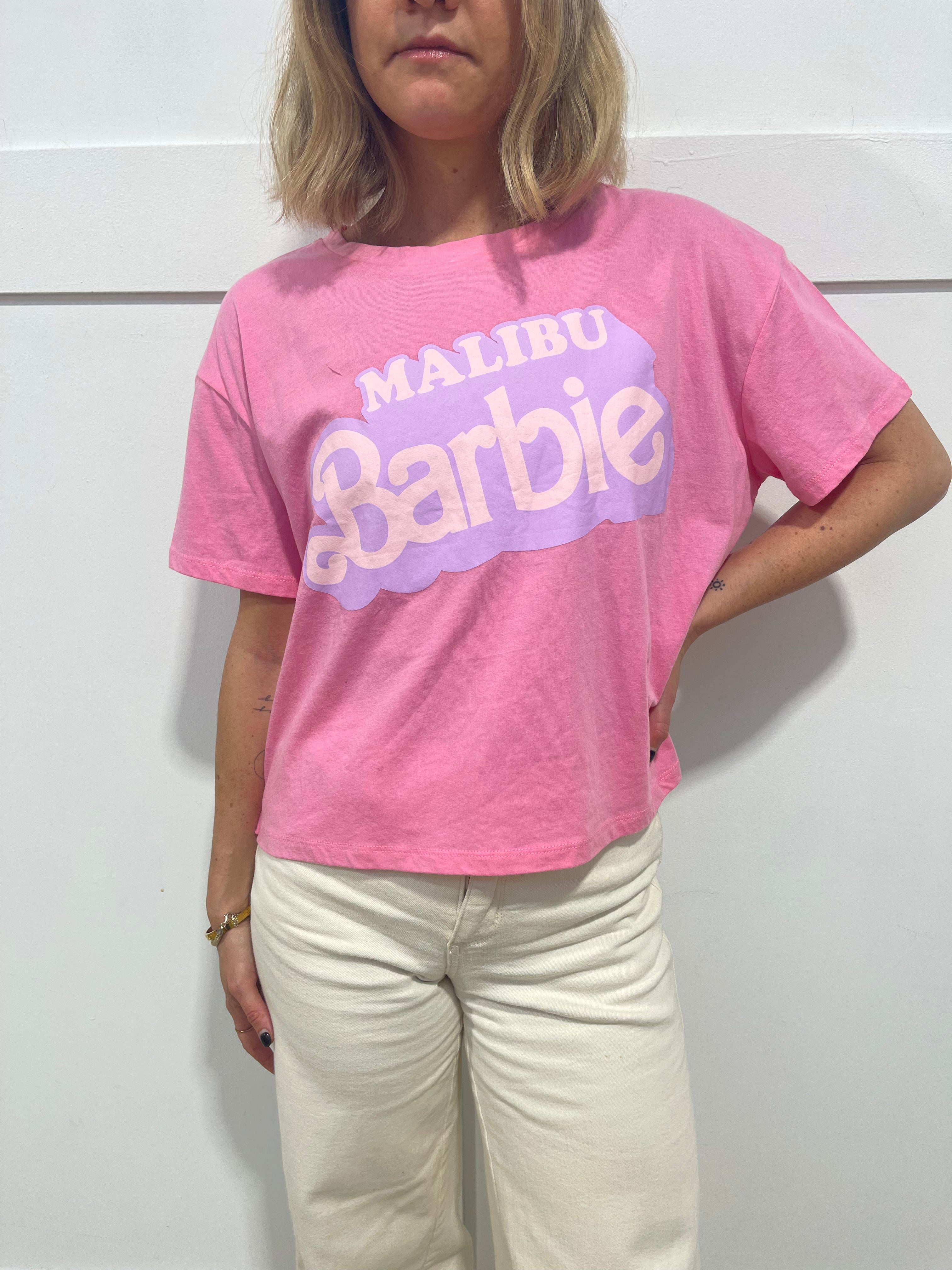 woman in pink Malibu barbie t shirt