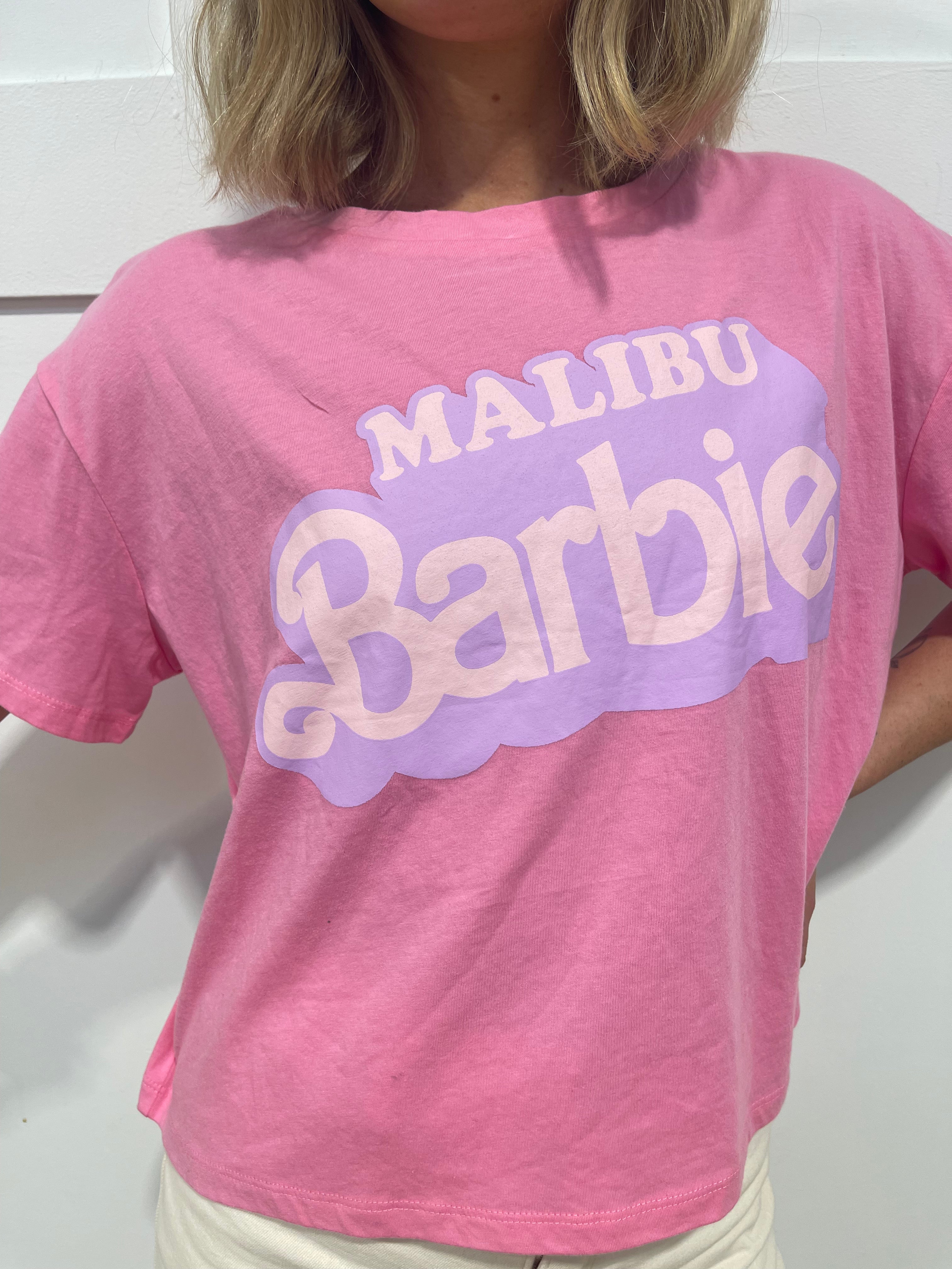 woman in pink Malibu barbie t shirt