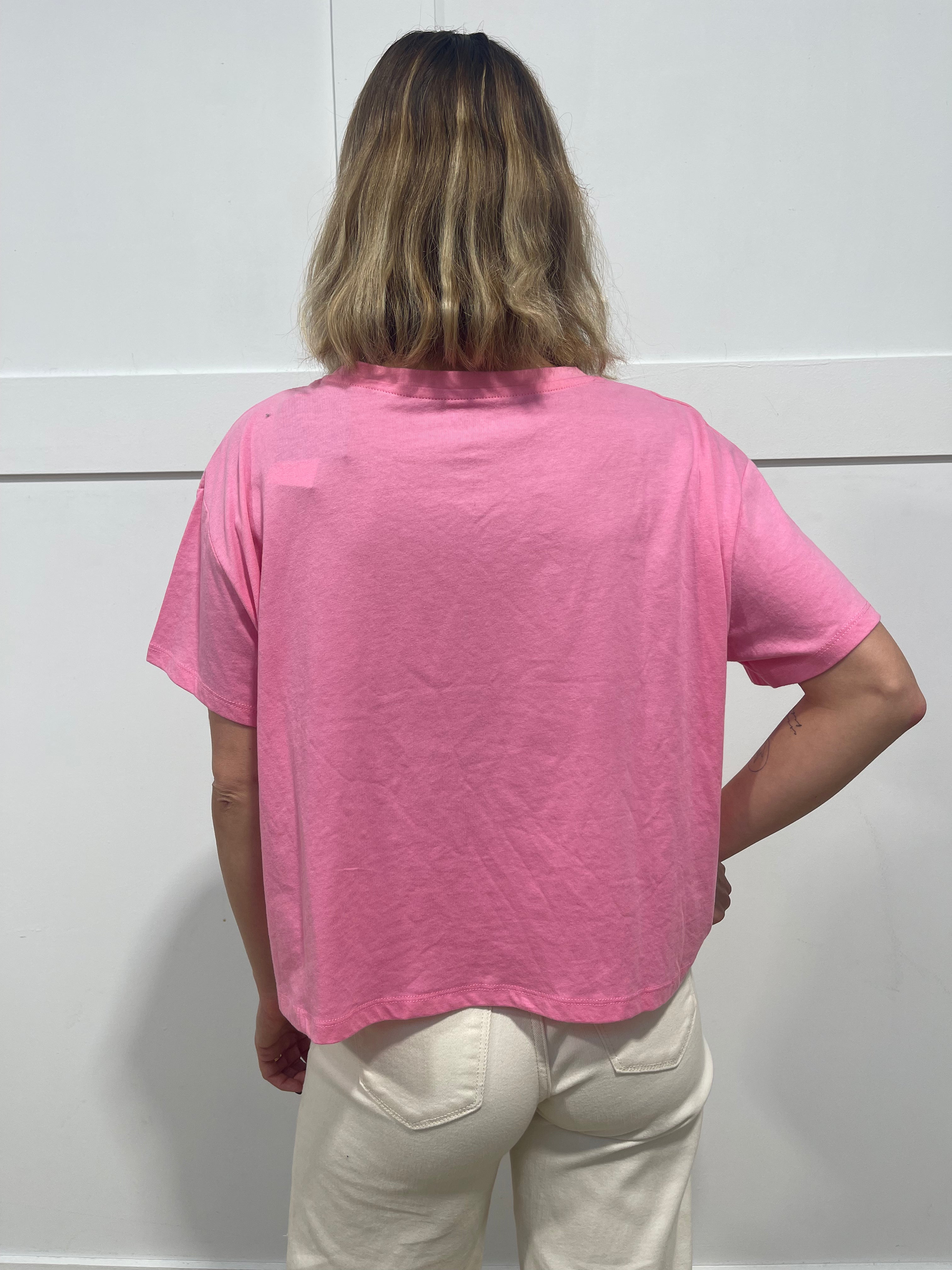 woman in pink Malibu barbie t shirt from behind